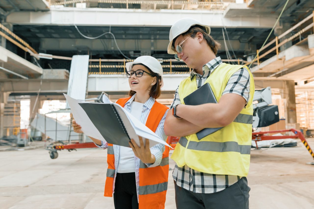 female construction inspector examining construction site